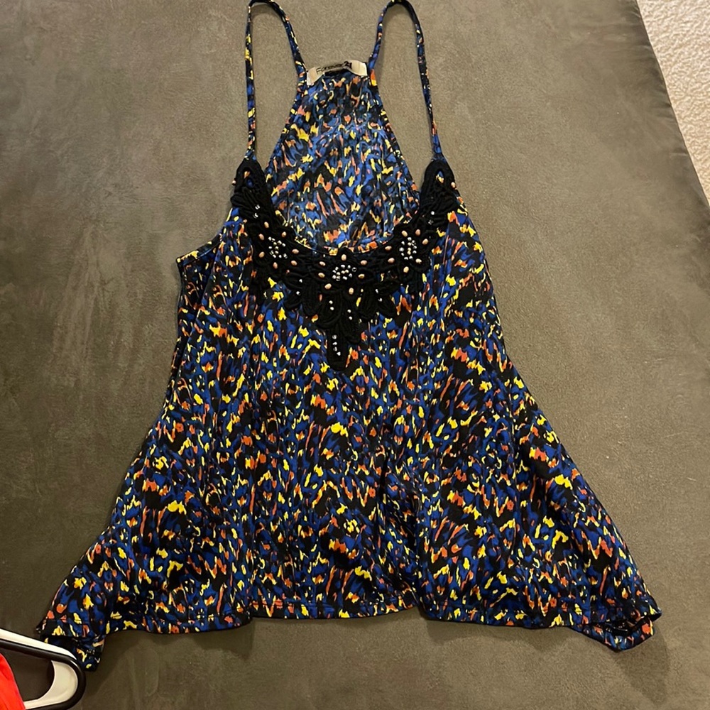 Asymmetrical flowy tank with beading details